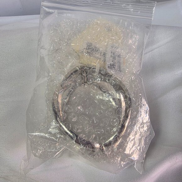 New Directions Silver Tone Knot Bangle Bracelet Featuring an Abstract Design - Picture 10 of 10